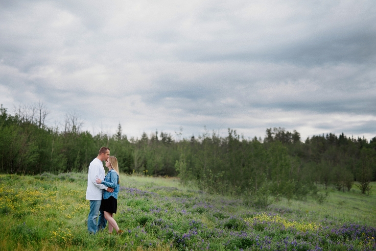 Edmonton engaged couple embraces under moody sky