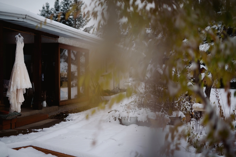 wedding dress hanging in snowy edmonton acreage